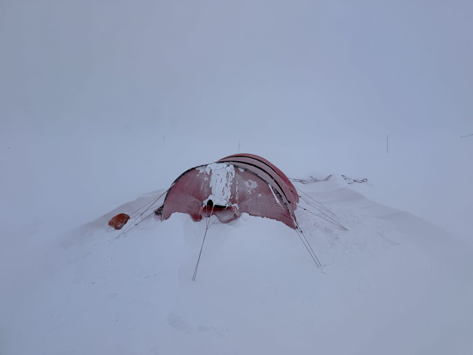 Our tent half-buried and armoured in ice after the blizzard hit the Hardangervidda